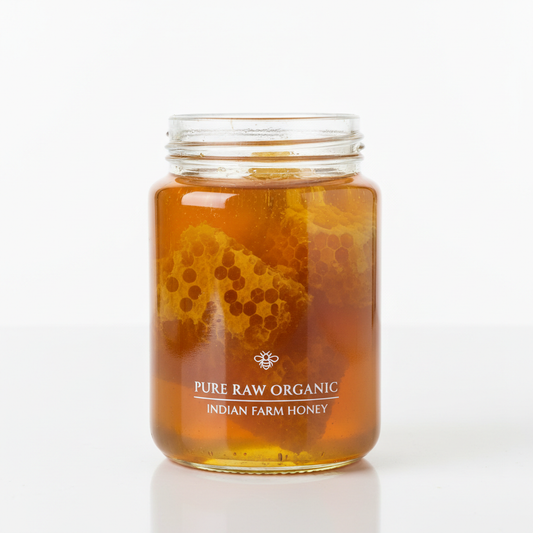 Raw forest honey in glass jar with honeycomb